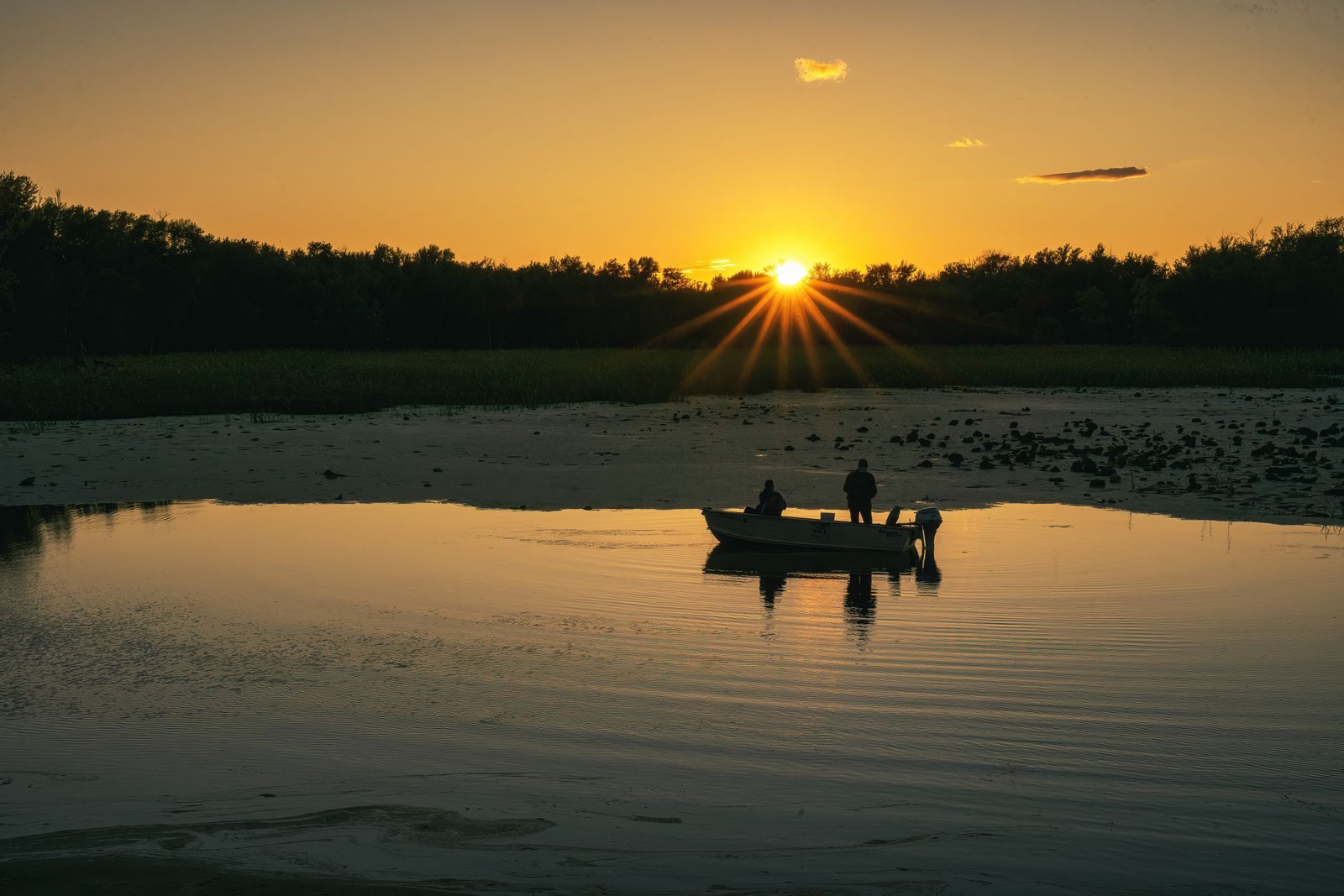 Small boat on the Mississippi at sunset