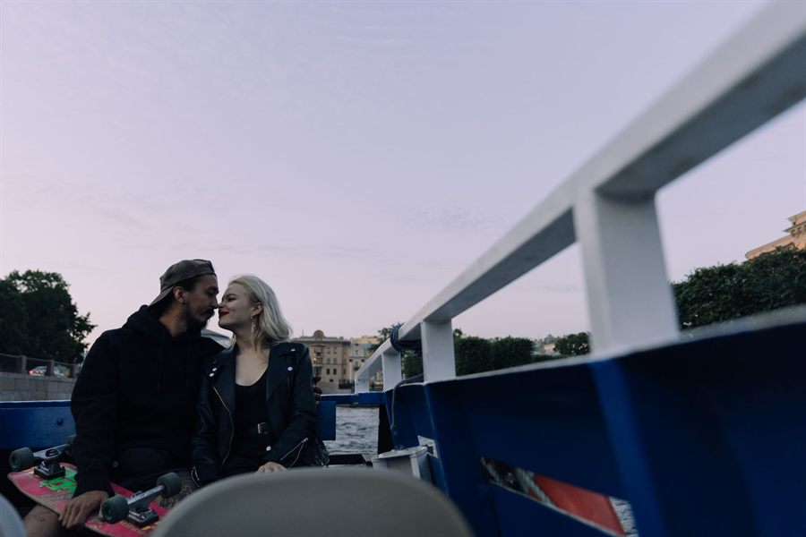 Couple on the deck of a river boat at dusk